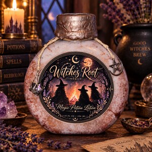 May include: A round bottle of Witches Root Magic Potion Lotion with a textured, marbled finish. The label features a campfire scene with three figures in hats, a crescent moon, and the text 10 FL OZ | 296 ML. A twine cord with a metal star charm hangs from the neck.