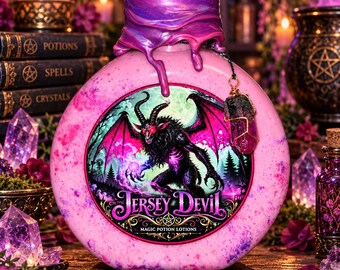 May include: A round pink bottle with a purple wax-sealed top and a hanging crystal charm. The front label features a black winged creature, a forest, and the text Jersey Devil Magic Potion Lotions in a decorative font style.