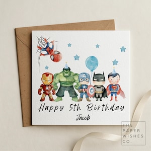 May include: A square birthday greeting card featuring watercolour illustrations of five chibi-style superheroes, including Spider-Man, Iron Man, Hulk, Captain America, Batman, and Superman. The text reads Happy 5th Birthday Jacob with blue stars.