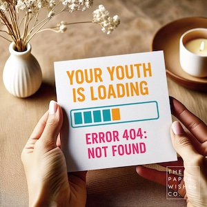 May include: A white card with the text "YOUR YOUTH IS LOADING" in orange and "ERROR 404: NOT FOUND" in pink. The card has a loading bar graphic in teal and orange. The card is held by two hands.
