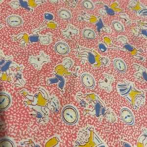 May include: Pink fabric with a repeating pattern of children playing. The children are wearing blue and yellow clothing and are holding various objects, including balloons, sticks, and clocks. The background is a pink and white speckled pattern.