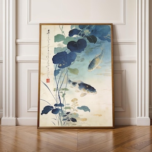 May include: A framed print of an Asian-inspired painting featuring two koi fish swimming in a pond with blue lily pads and aquatic plants. The artwork has a vintage aesthetic with soft colors and Japanese calligraphy.