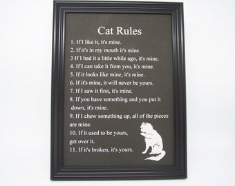 Framed Cat Rules. 4 3/4x 6 3/4 inside a 7 3/4 x 5 3/4 Black plastic frame. Tabletop or wall hanging