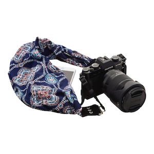 May include: A blue and red patterned camera strap with a black camera and lens attached. The camera has the text "FUJIFILM X-T30" on it.