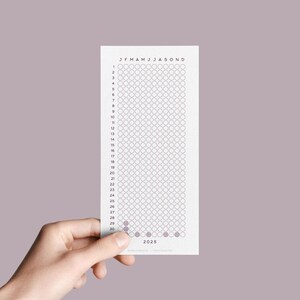 May include: A white printable calendar tracker with a grid of circles for each day of the year. The months are labelled across the top with the abbreviation "JFMAMJJASOND". The numbers 1 through 31 are listed down the left side. The year 2023 is printed at the bottom.