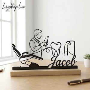 May include: A white ceramic mug with a black handle and the text "But First, Coffee" in a black, bold font. The mug is on a white surface. The mug is approximately 4 inches tall.