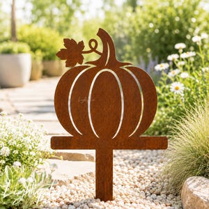 May include: A rust-colored metal garden stake shaped like a pumpkin with a single leaf on its stem. The pumpkin silhouette features vertical cutouts and is mounted on a straight, flat post designed for insertion into the ground.