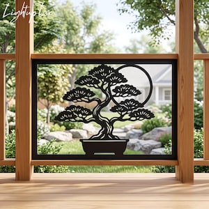 May include: A black metal decorative panel featuring a cutout silhouette of a bonsai tree in a rectangular pot with a circular moon shape behind the branches. The panel is framed in a black border and is mounted within a wooden railing structure.