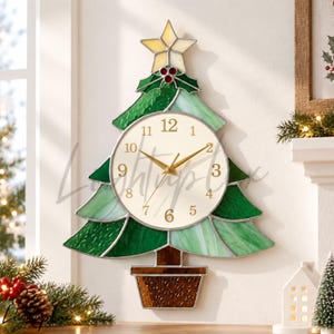 May include: A stained glass wall clock shaped like a Christmas tree with a cream-colored circular face, gold hands, and black numerals. The tree features various shades of green glass, a yellow star topper, red holly berries, and a brown base.
