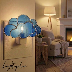 May include: A cloud-shaped night light with blue stained glass and a warm light bulb. The night light is plugged into a wall outlet. The text "LightupLux" is written in cursive at the bottom.