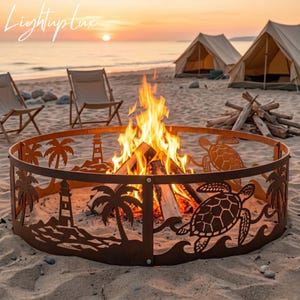 May include: A circular metal fire pit ring featuring laser-cut silhouettes of sea turtles, palm trees, and a lighthouse. The brown metal structure surrounds a bright, active fire with burning logs, set on a sandy beach at sunset.