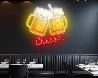 May include: A wall-mounted neon sign featuring two yellow beer mugs clinking together with white foam spilling over the top. Below the mugs, the word Cheers! is written in a bright red cursive neon script against a dark wall background.