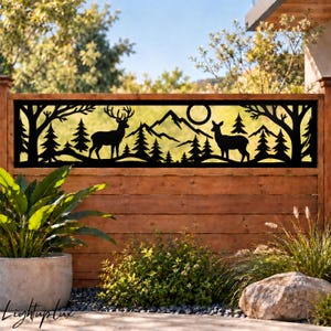 May include: A rectangular black metal decorative panel featuring a laser-cut silhouette of a forest landscape. The design includes a stag with antlers, a doe, pine trees, a mountain range, and a circular sun, all framed within a solid border.