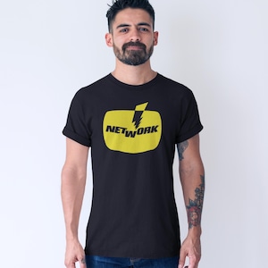 May include: Black t-shirt featuring a yellow rectangle with the word "NETWORK" and a lightning bolt graphic. The t-shirt is a classic crew neck style.
