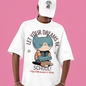 Continua a sognare e realizzalo! T-shirt unisex "Ritorno a scuola" con motivo a gatto e scritta "Scrivimi una frase".