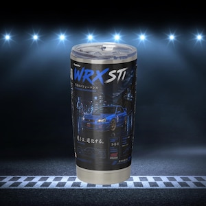 May include: A stainless steel tumbler featuring a blue Subaru WRX STI car graphic, the text WRX STI, and Japanese characters. The design includes a dark background with city lights, technical specifications, and a clear plastic lid on top.