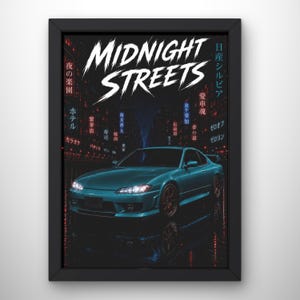 May include: A framed poster featuring a teal sports car parked on a dark city street at night. The text MIDNIGHT STREETS appears in large white letters at the top, surrounded by various Japanese characters and glowing red city lights.