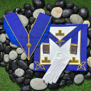 May include: A set of Masonic regalia, including a blue and gold collar, apron, and white gloves. The apron is white with blue trim and gold accents. The text "Handmade Mason Shop" is visible.