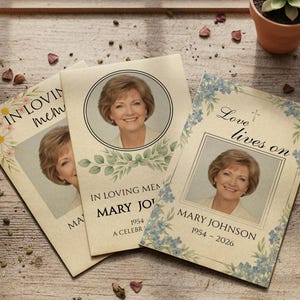 May include: Three memorial cards featuring a portrait of a woman. The cards are decorated with floral and botanical designs, and the text reads "In Loving Memory" and "Love lives on." The cards also include the name "Mary Johnson" and dates.