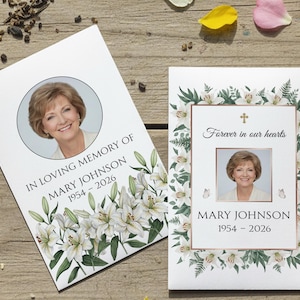 May include: Two memorial cards featuring a woman's photo, framed by floral and botanical elements. One card says "In Loving Memory of Mary Johnson 1954-2026." The other reads "Forever in our hearts" with the same name and dates.