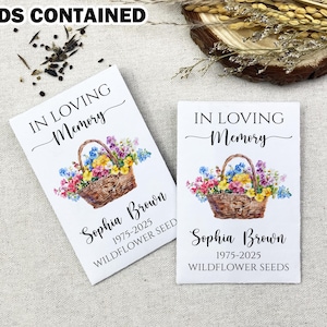 May include: Two white cards with a floral design and the text "In Loving Memory" with the name "Sophia Brown" and the dates "1975-2025" and the text "Wildflower Seeds".