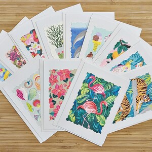 May include: A set of 12 blank greeting cards with colorful illustrations. The cards feature a variety of designs, including tropical flowers, animals, and abstract patterns. The cards are perfect for sending a personalized message to a loved one.