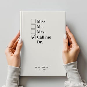 May include: A white notebook with the text "Miss, Ms., Mrs., Call me Dr." and a checkmark next to "Dr.". The notebook also includes the text "DR. JACKSON, PH.D EST. 2026".