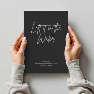 May include: A black journal with the text "Left it in the Water" in white script. The journal also includes the name "Emily Jane", the date "September 19th, 2025", and "St. Mary's Church".