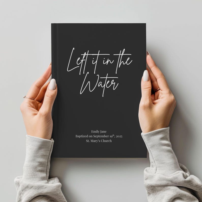 May include: A black journal with the text "Left it in the Water" in white script. The journal also includes the name "Emily Jane", the date "September 19th, 2025", and "St. Mary's Church".