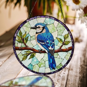 a blue bird sitting on a branch of a tree