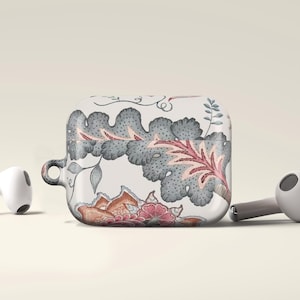May include: White AirPods and a matching case with a floral design in gray, pink, and orange. The case has a loop for attaching to a keychain. The earbuds are on a light background.