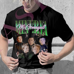 May include: A light pink t-shirt and a black t-shirt, each featuring a graphic of a group of people in witch hats. The text "MINERVA McGonagall" is above the image in green and white. The people are wearing black robes.