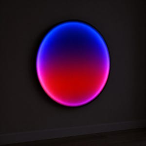 Arte de parede iluminada, luminária redonda de acrílico com degradê azul e rosa.