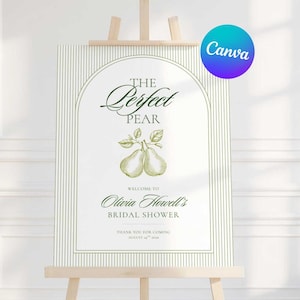 以下が含まれることがあります： 木製のイーゼルに立てられた白い看板。テキスト「The Perfect Pear」がエレガントな筆記体で書かれ、梨のイラストが添えられています。看板はオリビア・ハウエルのブライダルシャワーへのゲストを歓迎します。Canvaのロゴが右上隅にあります。