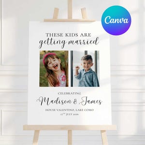 Op de afbeelding: Een wit bord op een houten ezel met de tekst "THESE KIDS ARE getting married". Er worden twee foto's van kinderen weergegeven. Het bord viert de bruiloft van Madison & James in House Valentino, Lake Como, op 17 juli 2026. Een Canva-logo staat rechtsboven.