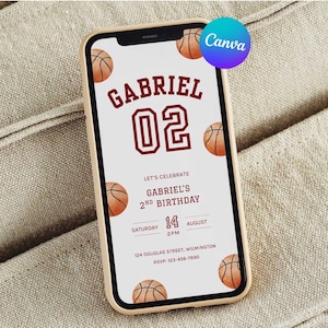 May include: A smartphone displays a basketball-themed birthday invitation. The invitation features the name "GABRIEL" and the number "02" in maroon, along with basketball illustrations. The text reads "LET'S CELEBRATE GABRIEL'S 2ND BIRTHDAY" with date and time details.
