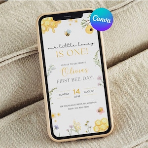 May include: A smartphone displays a custom invitation for a first birthday party. The invitation features a bee theme with floral and honeycomb illustrations. Text includes "Our little honey is one!" and event details.