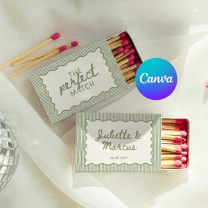 May include: Two rectangular matchboxes with green and white pinstriped covers. One box features the text "THE perfect MATCH" and the other "Juliette & Marcus 10.18.2027" inside a scalloped frame. Both boxes contain wooden matches with pink tips.