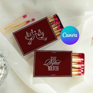 May include: Two rectangular matchboxes with a deep burgundy finish. One box features a white line drawing of two birds, while the other displays the white text "THE PERFECT MATCH" in a stylized font. Both boxes contain wooden matches with pink tips.