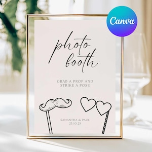May include: A framed sign with the words "photo booth" in elegant script. Below, it reads "Grab a prop and strike a pose." Includes illustrations of a mustache and heart-shaped glasses on sticks. The sign is for Samantha & Paul, dated 23.10.25.