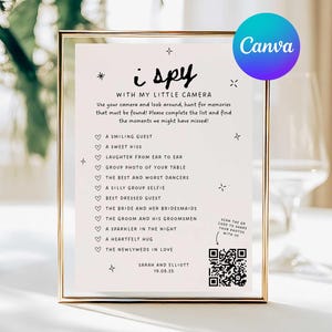 May include: A framed wedding game card with the text "i spy" and a list of prompts to capture memories. The card is in a gold frame and includes a QR code for sharing photos. The Canva logo is visible.