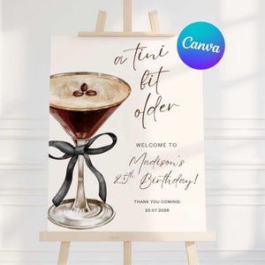 May include: A sign on an easel with a watercolor illustration of a martini glass with coffee beans. Text reads "a tini bit older" and "Welcome to Madison's 25th Birthday!" with the date 25.07.2026.