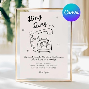 May include: A framed sign with a gold border features a black and white illustration of a vintage telephone. The text "Ring Ring" is above the phone graphic. Below the graphic, the sign reads "We can't come to the phone right now... please leave us a message."