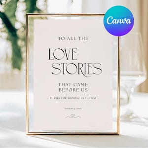 May include: A framed sign with gold trim and a white background. The sign reads "TO ALL THE LOVE STORIES THAT CAME BEFORE US." The Canva logo is in the upper right corner. The sign is likely for a wedding or special event.