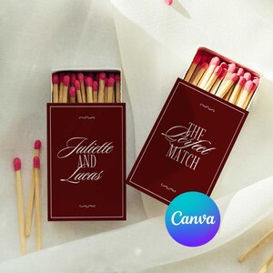 May include: Two rectangular matchboxes with deep red covers and white text. One box reads Juliette AND Lucas, the other reads THE Perfect MATCH. Both boxes are filled with wooden matches featuring bright pink tips. Loose matches with pink tips are scattered nearby.