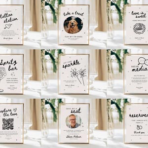 May include: A collection of framed signs with gold borders, featuring various event-themed messages in black script. Messages include "tattoo station," "take a treat," "love is sweet," "Spritz bar," "let love sparkle," "social media," "capture the love," "save me a seat," and "reserved."