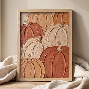 May include: A rectangular wall art piece in a light wood frame featuring a textured impasto painting of multiple pumpkins. The pumpkins are rendered in shades of terracotta, burnt orange, beige, and cream with visible thick paint strokes.