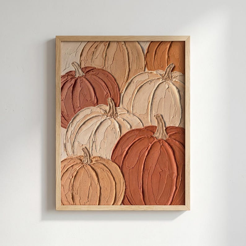 May include: A framed wall art piece featuring a textured impasto painting of multiple pumpkins in shades of cream, beige, tan, and burnt orange. The artwork displays thick, visible brushstrokes and raised paint layers, encased in a light wood frame.
