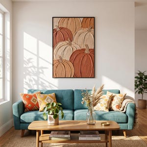 May include: A rectangular wall art piece featuring a textured, impasto-style painting of multiple pumpkins in shades of terracotta, burnt orange, cream, and beige. The artwork is framed in a thin black border and displays visible brushstroke textures.