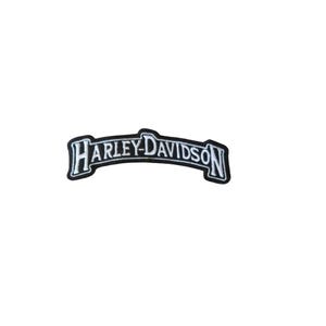 May include: A black and white Harley-Davidson patch with a curved banner design. The text "HARLEY-DAVIDSON" is in a bold, stylized font. The patch has a white border.